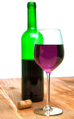 Wine glass and bottle on a wooden table