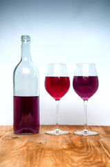 Wine glass and bottle on a wooden table