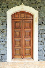 Wooden front door of a home. Front view of a wooden front door