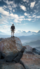Winner silhouette on the mountain top. Sport and active life concept..