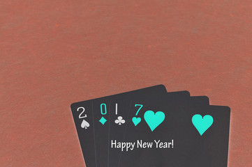 Obraz premium 2017 made out of playing cards with the words happy new year written on it with an invert effect on the photo