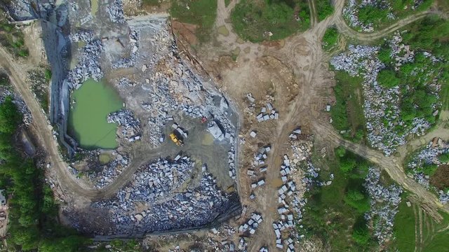 Flying over a stone quarry. Extraction of granite stone. aerial survey