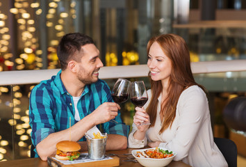 happy couple dining and drink wine at restaurant