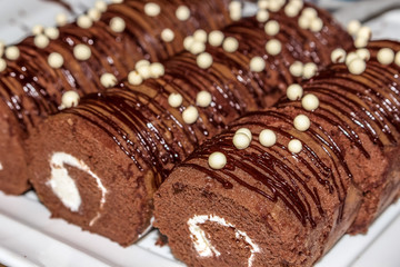 Close up beautiful chocolate Yam Roll  in white plate