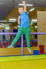 Exuberant young boy bouncing on a trampoline