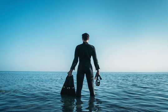 Diver man standing in the sea