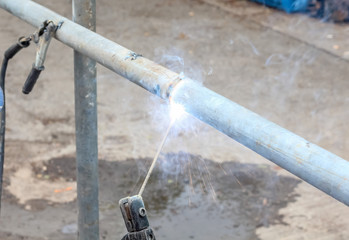 close up construction worker using butt-welding a pipe