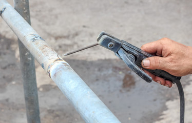 close up construction worker using butt-welding a pipe