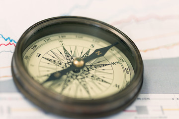 A compass on charts. A direction of success