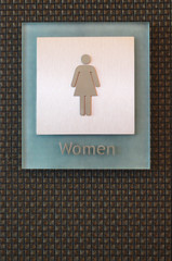 woman tolet sign at the black wall