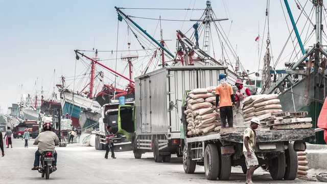 Loading of building materials on the old wooden ships. 4K Timelapse - Jakarta, Java, Indonesia, June 2016.