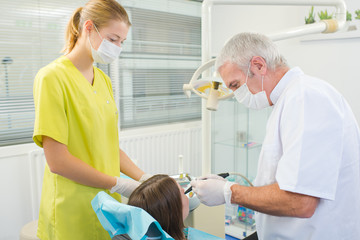 Busy dentist with a patient