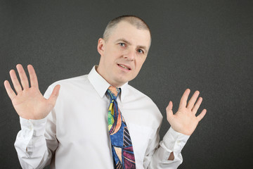 business man in white shirt shows open palms
