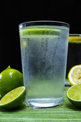 Glass with cold sparkling mineral water with fresh lime