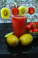 Fresh pressed strawberry and gold kiwi juice in a glass