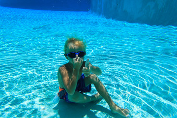 little boy swimming underwater, active kids