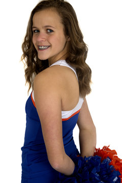 Sideview of a teenage girl cheerleader with a big smile wearing