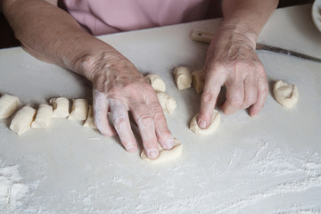 Senior woman baking pies in her home kitchen