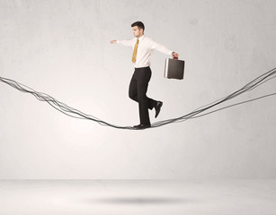 Sales person balancing on drawn ropes