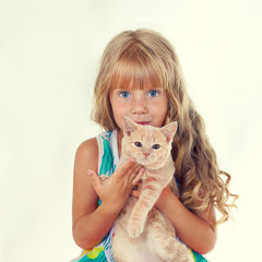 Cute girl hugging a little cat isolated on white background