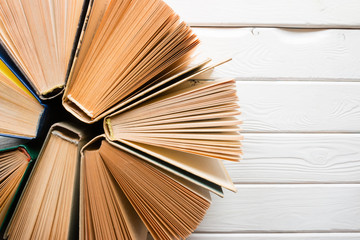 open vintage book in the form of a circle with space for text on a white wooden background