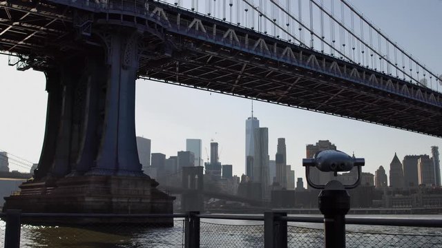 Tourist binoculars at Manhattan bridge. Manhattan skyline on background.