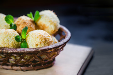 Coconut cookies in a basket with mint, a tasty dessert