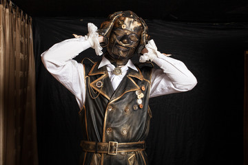 Man in a mask  in a cyborg costume against black background