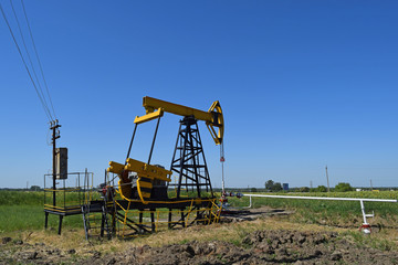 Fototapeta na wymiar Pumping unit as the oil pump installed on a well