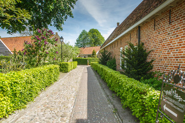 A street with houses and gardens in the historic fortress town of Bourtange, Groningen, the...