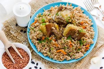 Pilaf from rice devzira with lamb, spices and vegetables