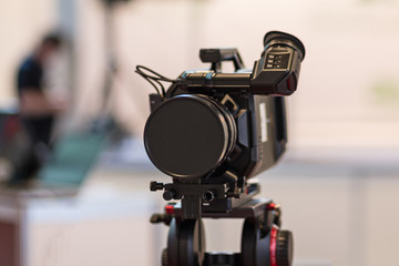 Video camera on a tripod and a blurred background