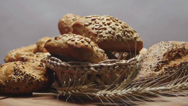 Bakery bread on a wooden table, rotating