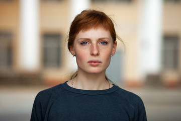 Young redhead caucasian woman serious face outdoor portrait - Powered by Adobe