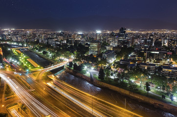 Fototapeta na wymiar Night view of Santiago de Chile toward the east part of the city, showing the Mapocho river and Providencia and Las Condes districts