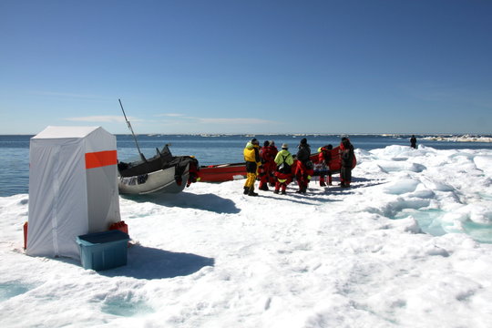 Tourists on ice floe in Arctic Ocean