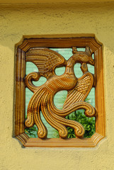bird in the window of a Chinese temple in kuala lumpur, Malaysia