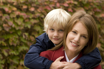 Mother and son outside on a fall day.