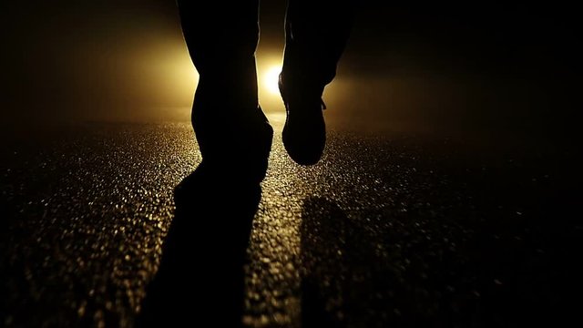 feet walking into dark night. criminal crime scene. spooky mystic mood