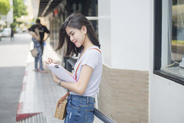 A portrait of an Asian university student on campus