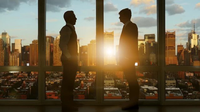 business people in high rise office building. city skyline window view