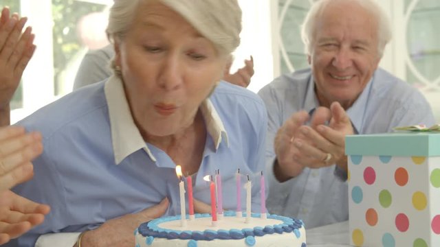 Grandmother Blows Out Candles On Birthday Cake, Slow Motion