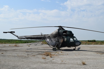 Fototapeta na wymiar Old helicopter spraying fields