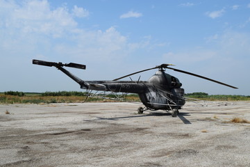 Fototapeta na wymiar Old helicopter spraying fields