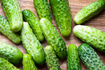The image of fresh cucumber on a wooden table