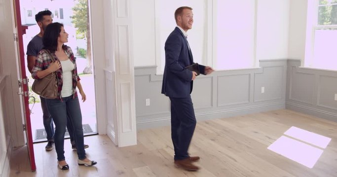 Realtor Showing Couple Around New Home 