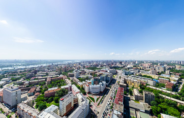 Aerial city view with crossroads and roads, houses, buildings, parks and parking lots, bridges. Urban landscape. Copter shot. Panoramic image.