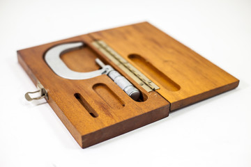 vintage Brown and Sharpe Micrometer with old wood box on white background 
