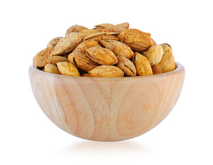 almonds in wood bowl isolated on white background