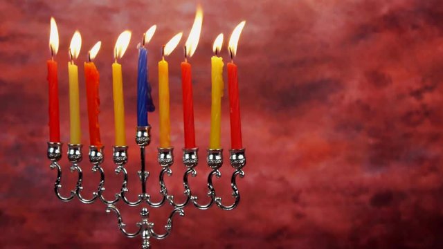Chanukah candles all in a row. Bright, shiny multicolor candles for the Jewish holiday.